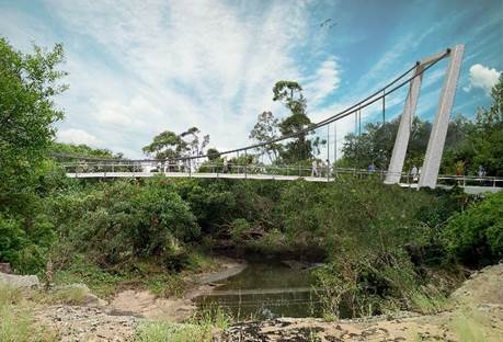 A suspension bridge over a stream

Description automatically generated